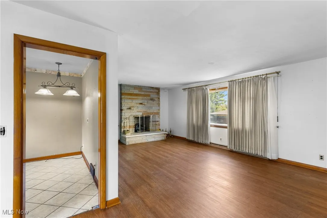 Unfurnished living room featuring a fireplace and wood finished floors