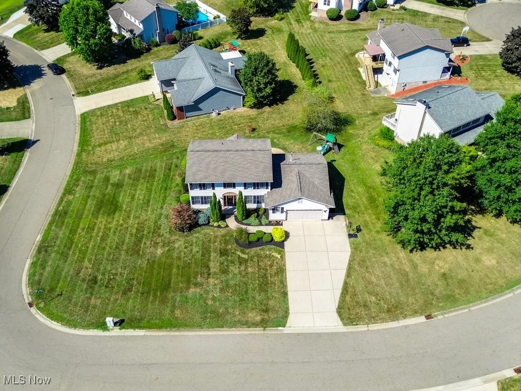 Below grade area featuring carpet, a drop ceiling, and recessed lighting