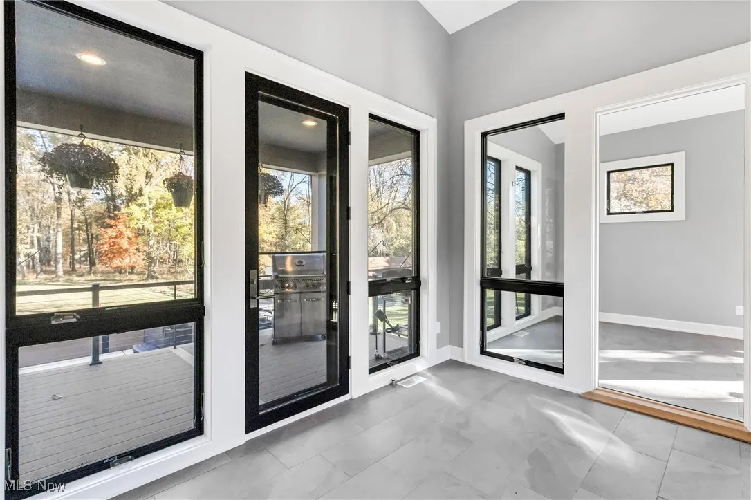Doorway to outside featuring baseboards