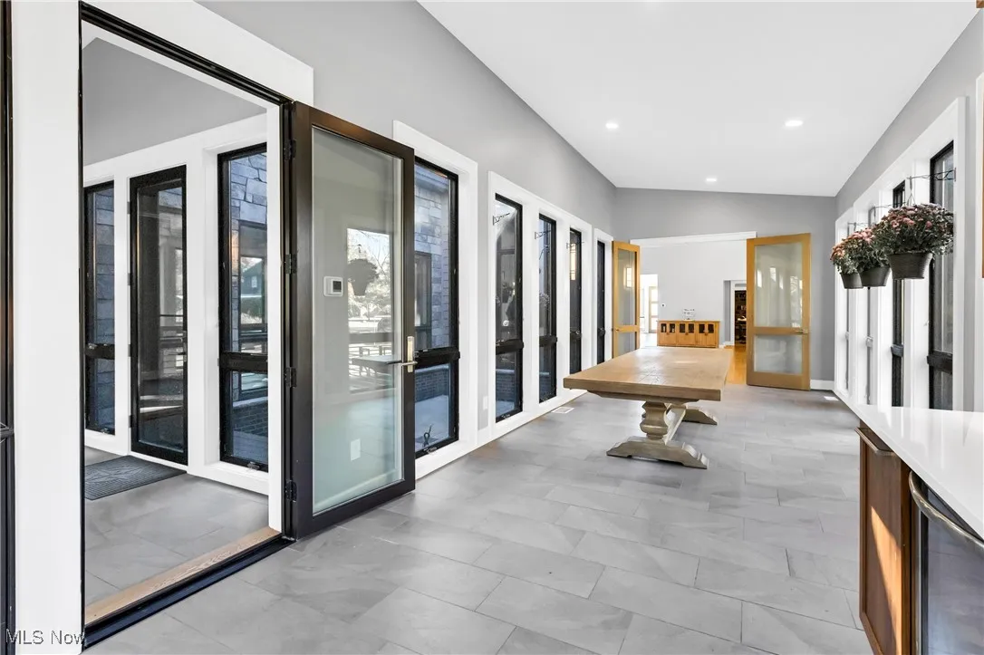 Hallway featuring wine cooler, lofted ceiling, and recessed lighting