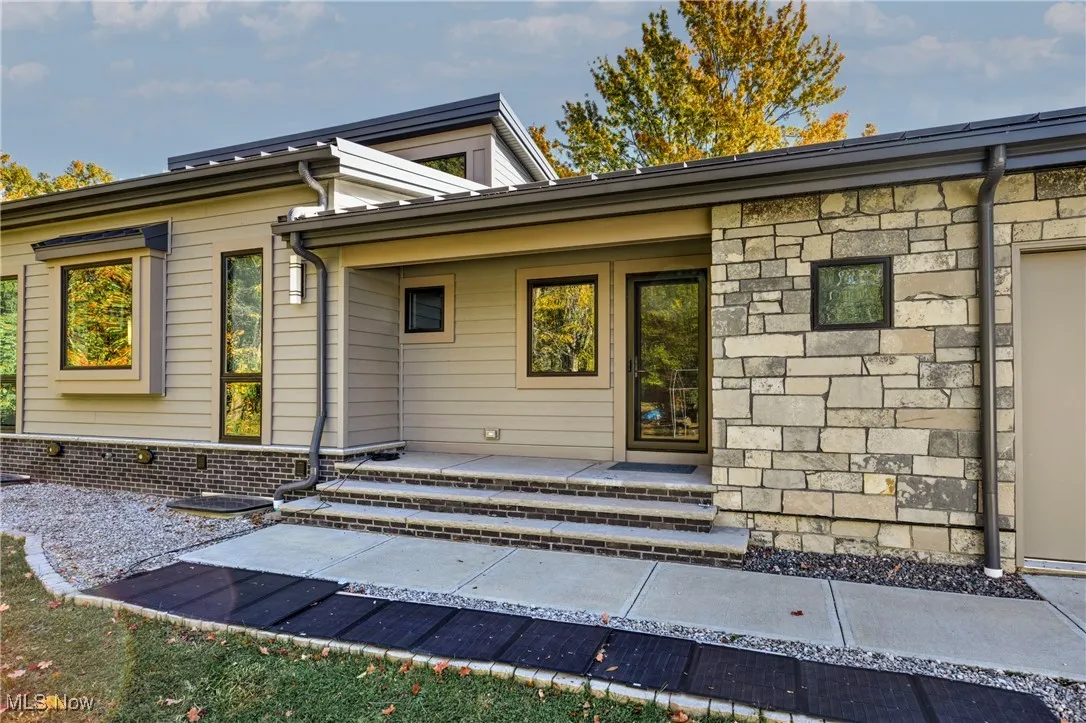 Side Property entrance with stone siding