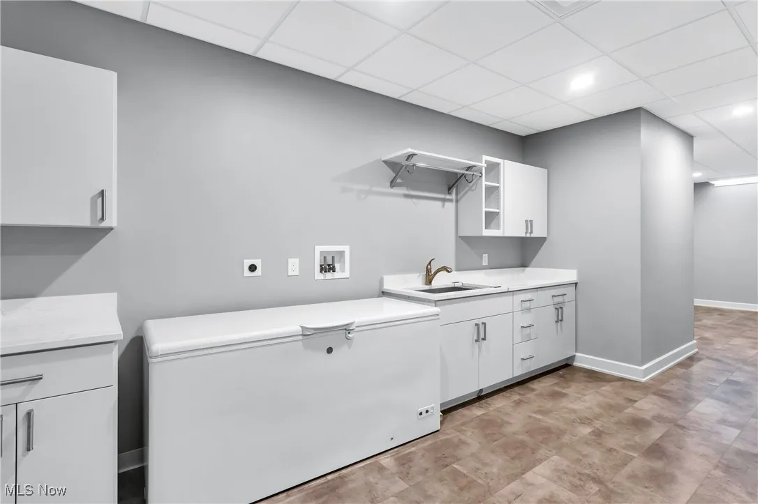 Laundry room with hookup for a washing machine, a paneled ceiling, cabinet space, hookup for an electric dryer, and recessed lighting