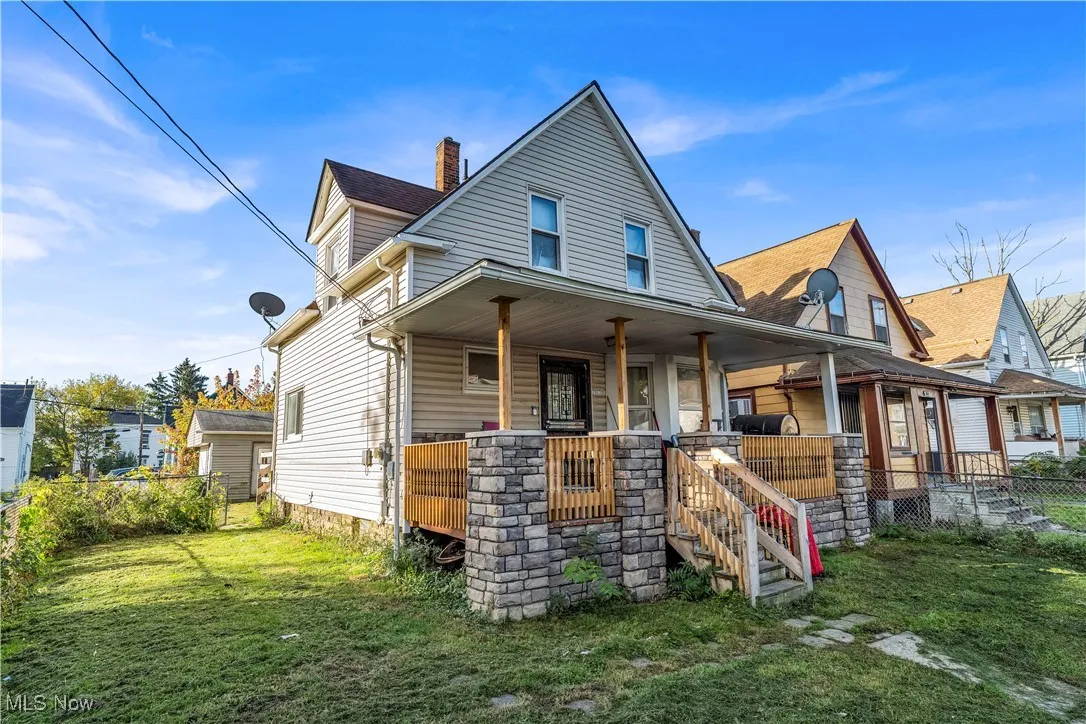 View of front of home featuring covered porch and a chimney