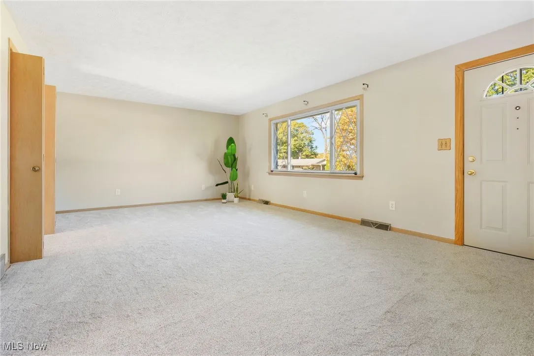 Living room with brand new carpet and picture window