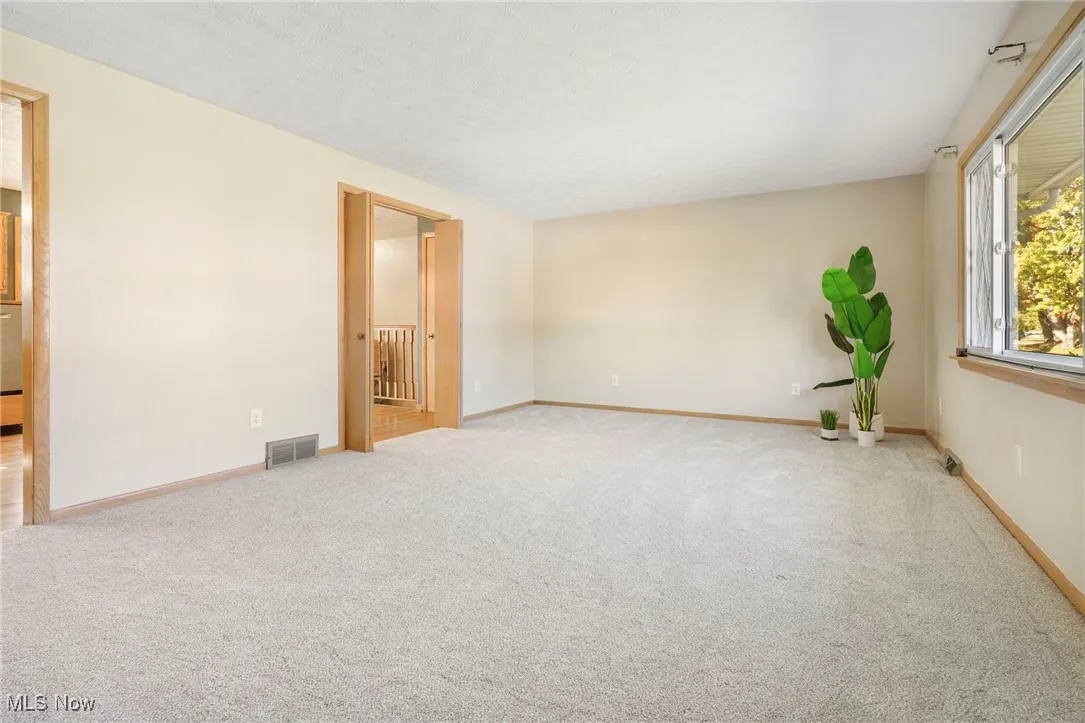 Living room featuring picture window and brand new carpet