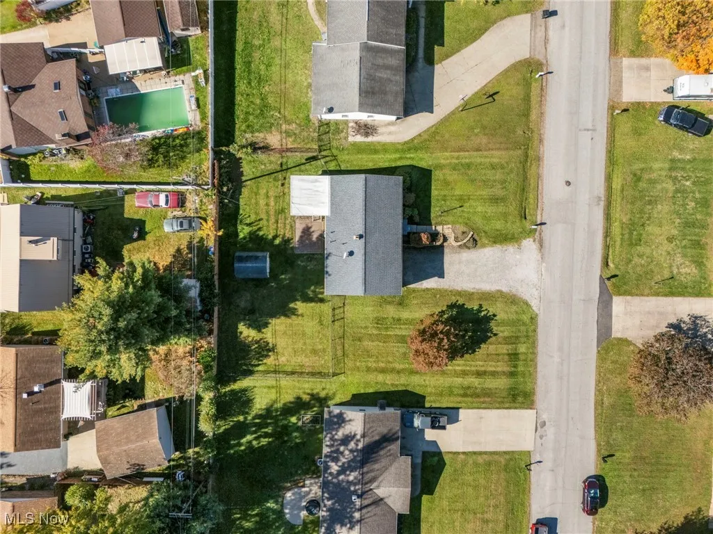 Aerial view of property's location with nearby suburban area