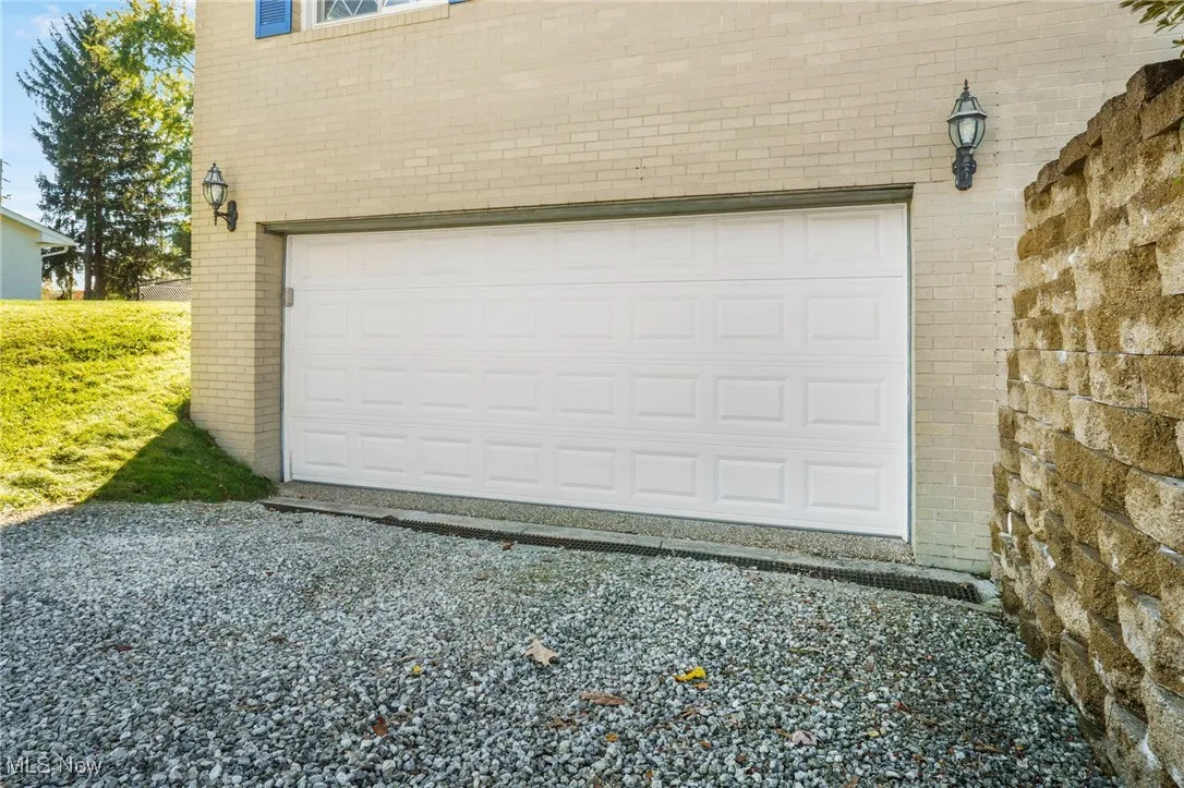 Garage with gravel driveway