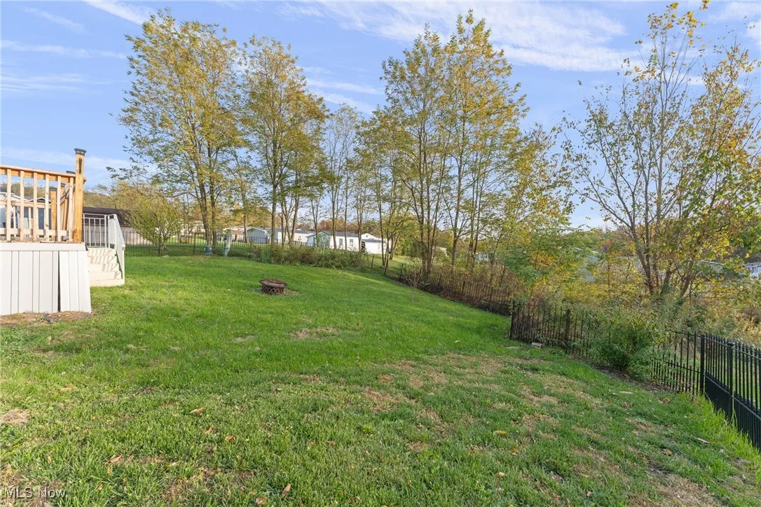 Fenced backyard featuring an outdoor fire pit