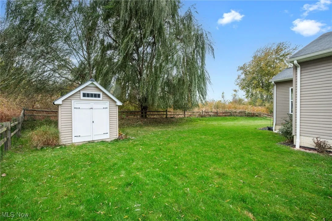 Fenced backyard with a storage shed