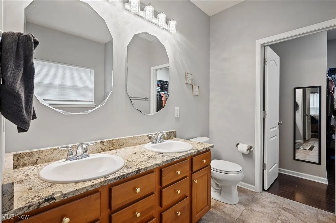 Master Bathroom featuring double vanity and a walk in closet