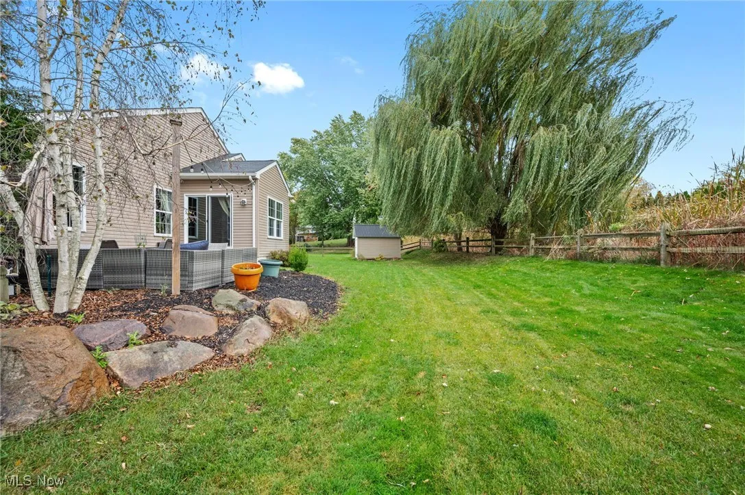 Fenced backyard with a storage unit