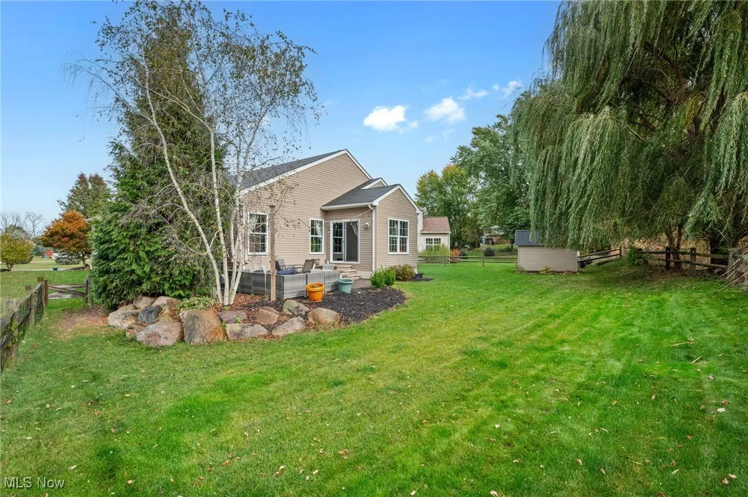 Rear view of property with a fenced backyard