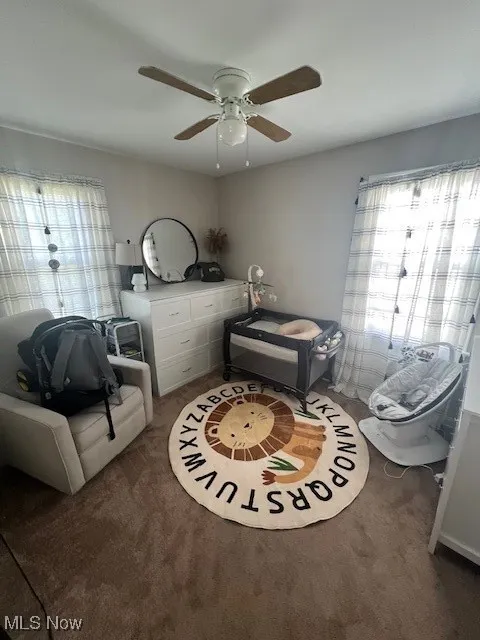 Bedroom featuring ceiling fan and carpet floors