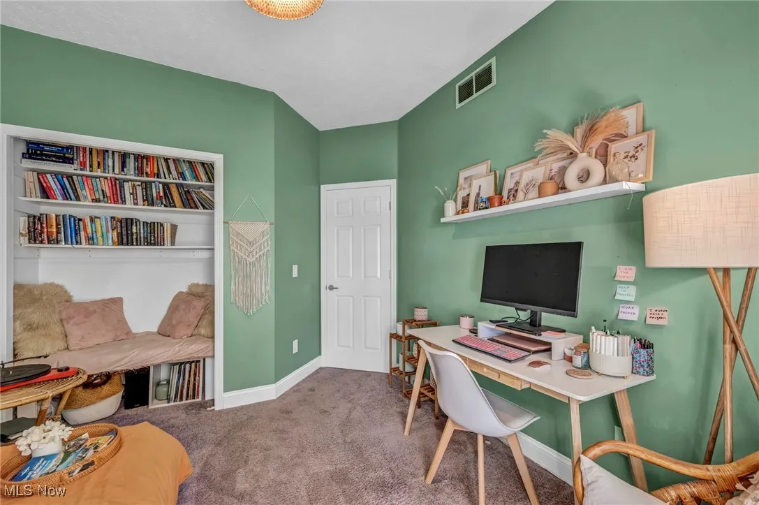 Carpeted home office with baseboards
