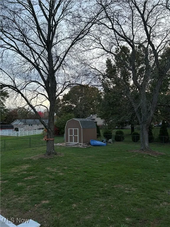 Fenced backyard with a storage shed