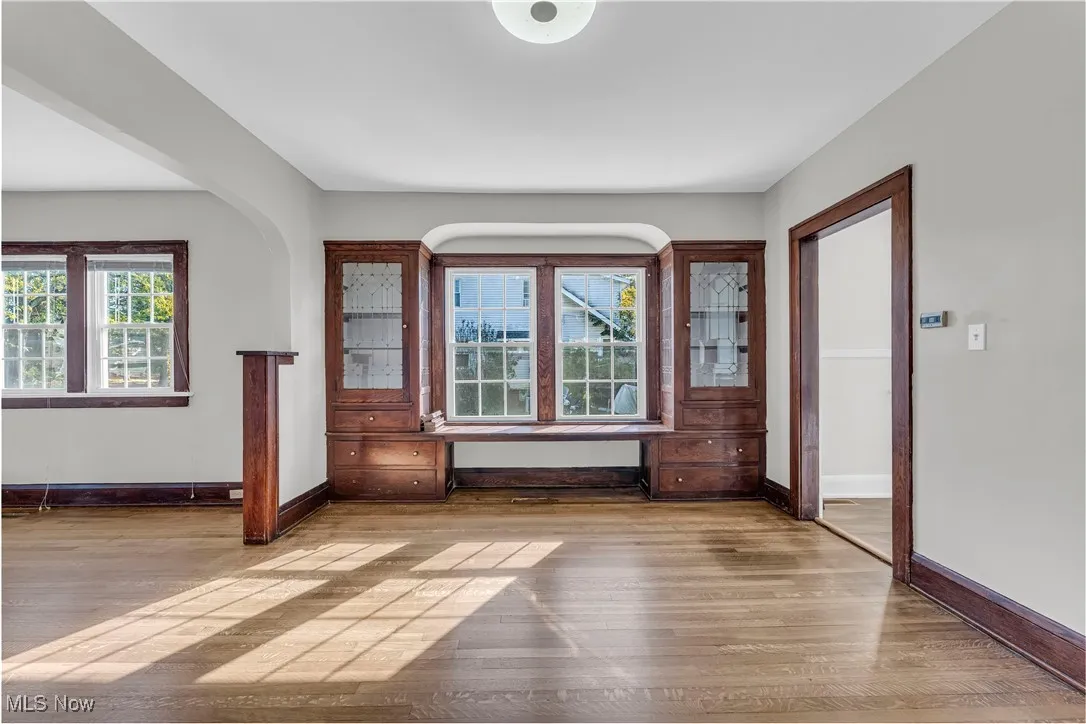 Unfurnished room with light wood-style flooring and baseboards