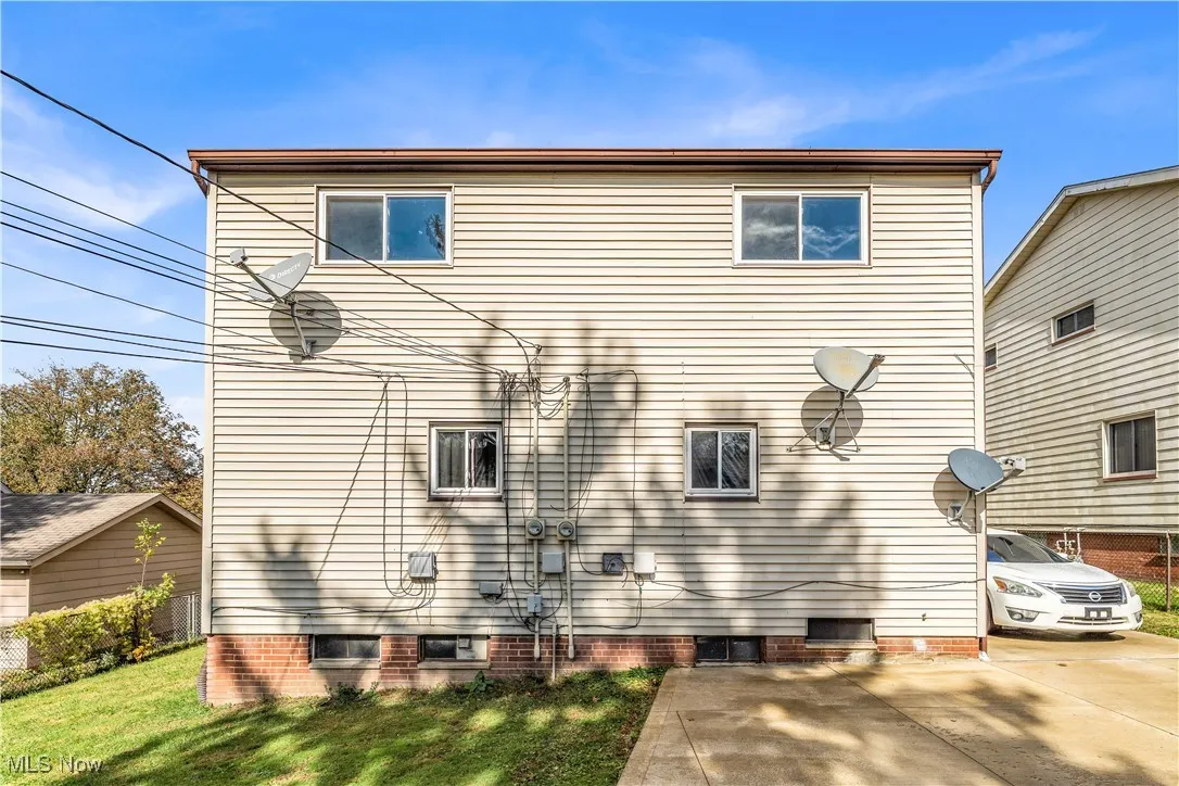 Back of property with a lawn