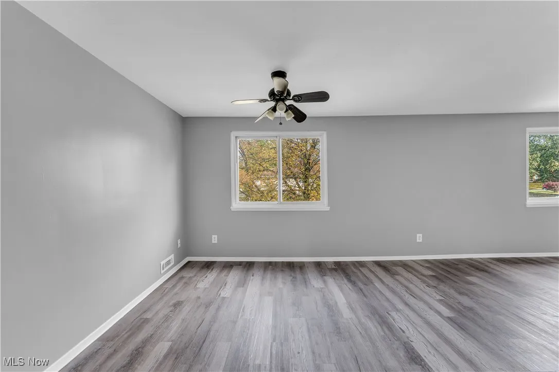 Spare room featuring light wood-style floors and a ceiling fan