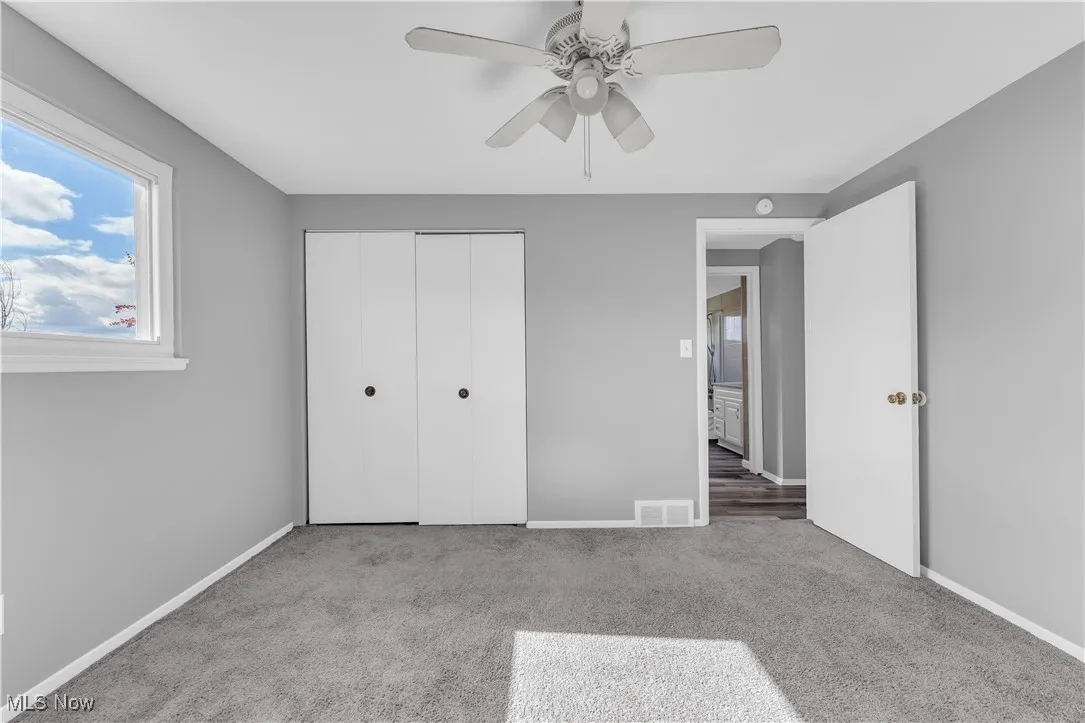 Unfurnished bedroom with carpet flooring, a closet, and ceiling fan