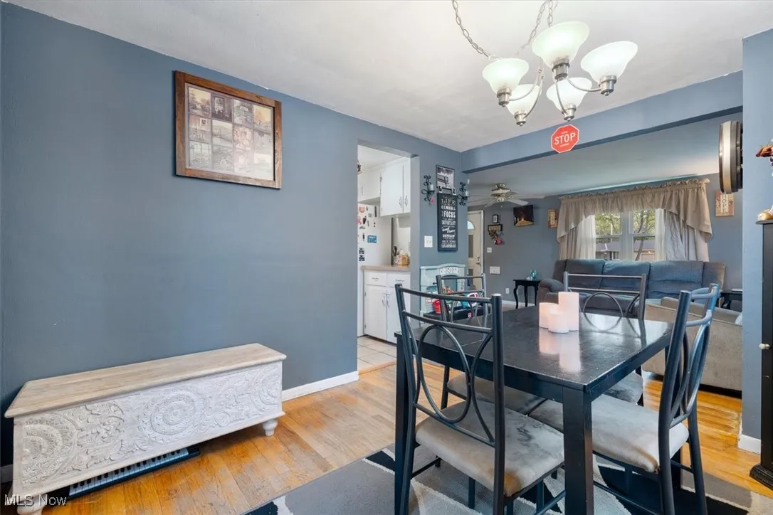 Dining area featuring a chandelier, light wood-style floors, and ceiling fan