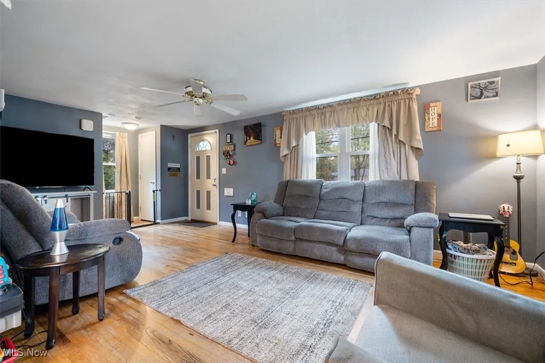 Living room featuring wood finished floors and ceiling fan