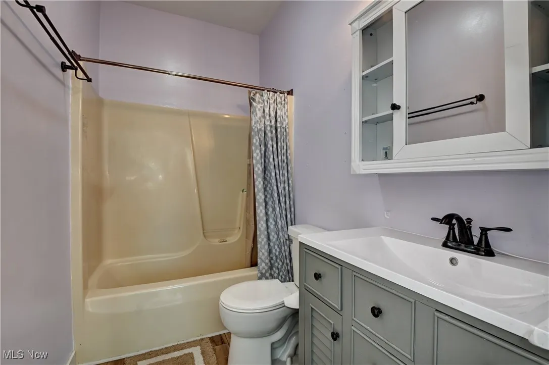 Full bathroom with vanity and shower / bath combo with shower curtain