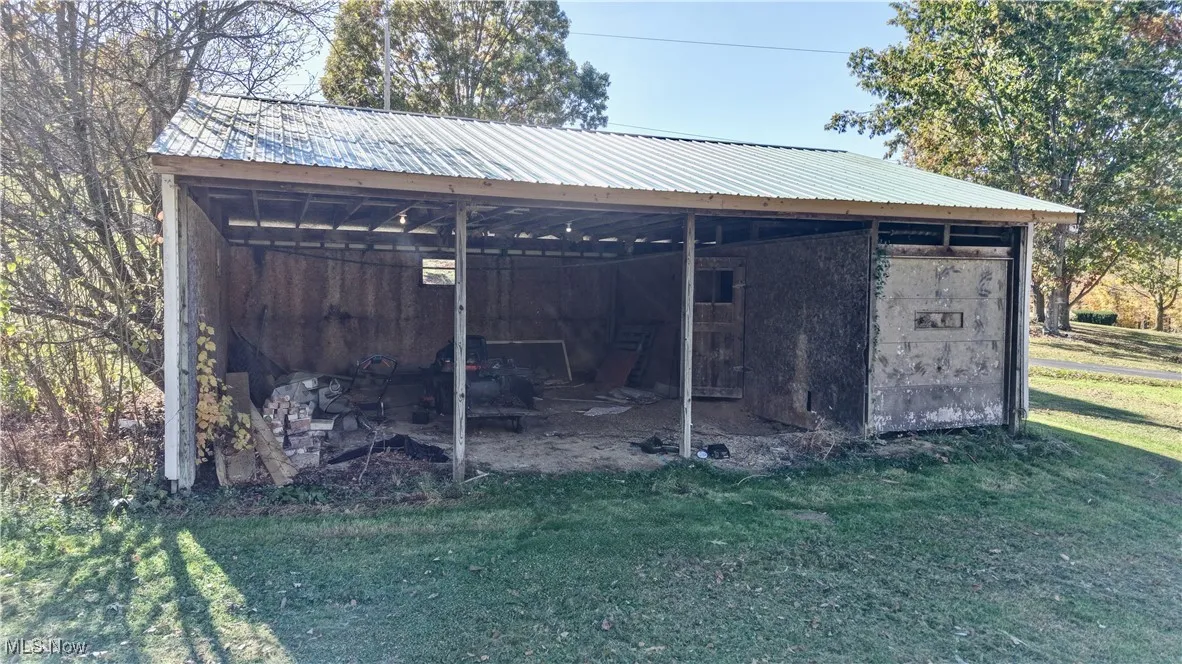 View of pole building featuring a lawn