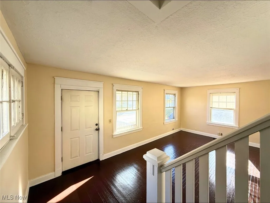 FH-Entryway featuring a textured ceiling and dark wood finished floors