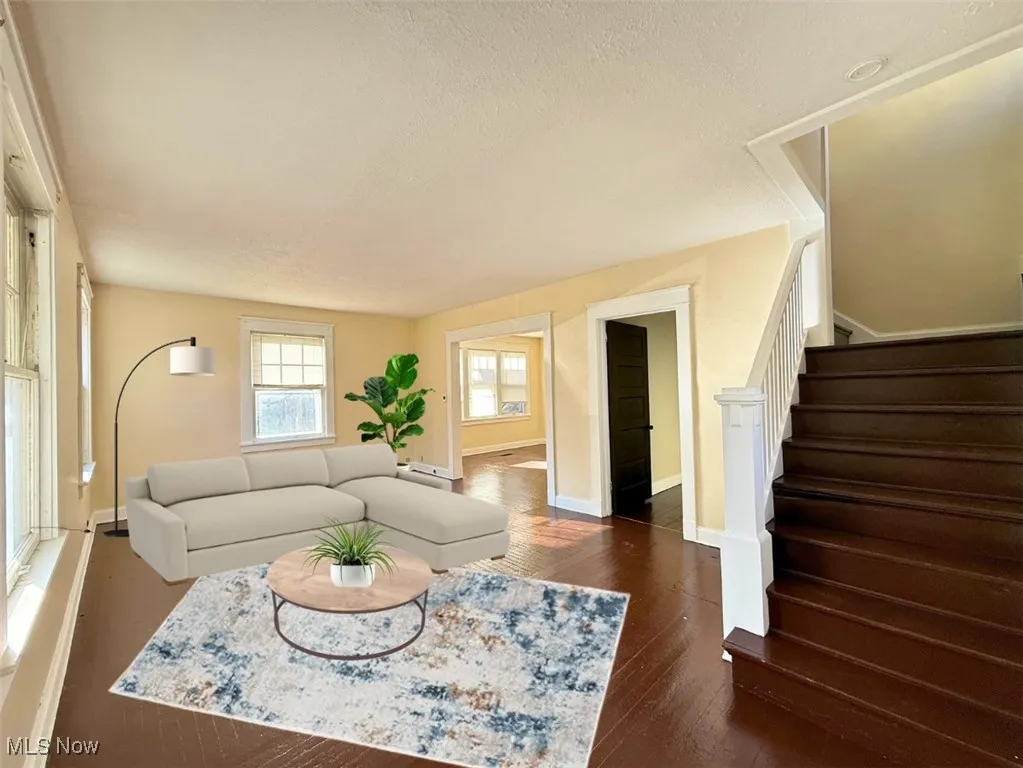 FH-E-STAGED-Living room with stairs, dark wood finished floors, a textured ceiling, and baseboard heating