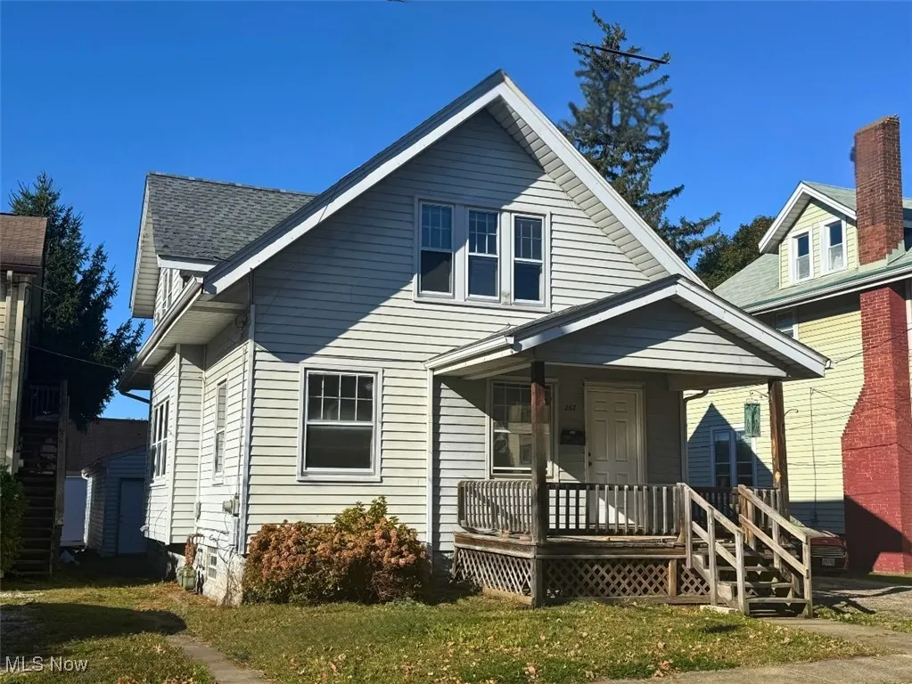 FRONT HOUSE Bungalow STYLE, 2- STORY with covered porch and a front lawn