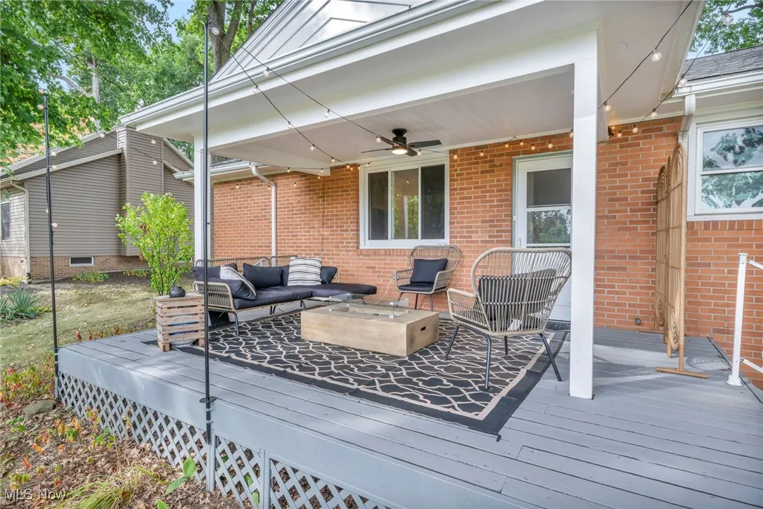 Wooden terrace featuring outdoor lounge area and ceiling fan