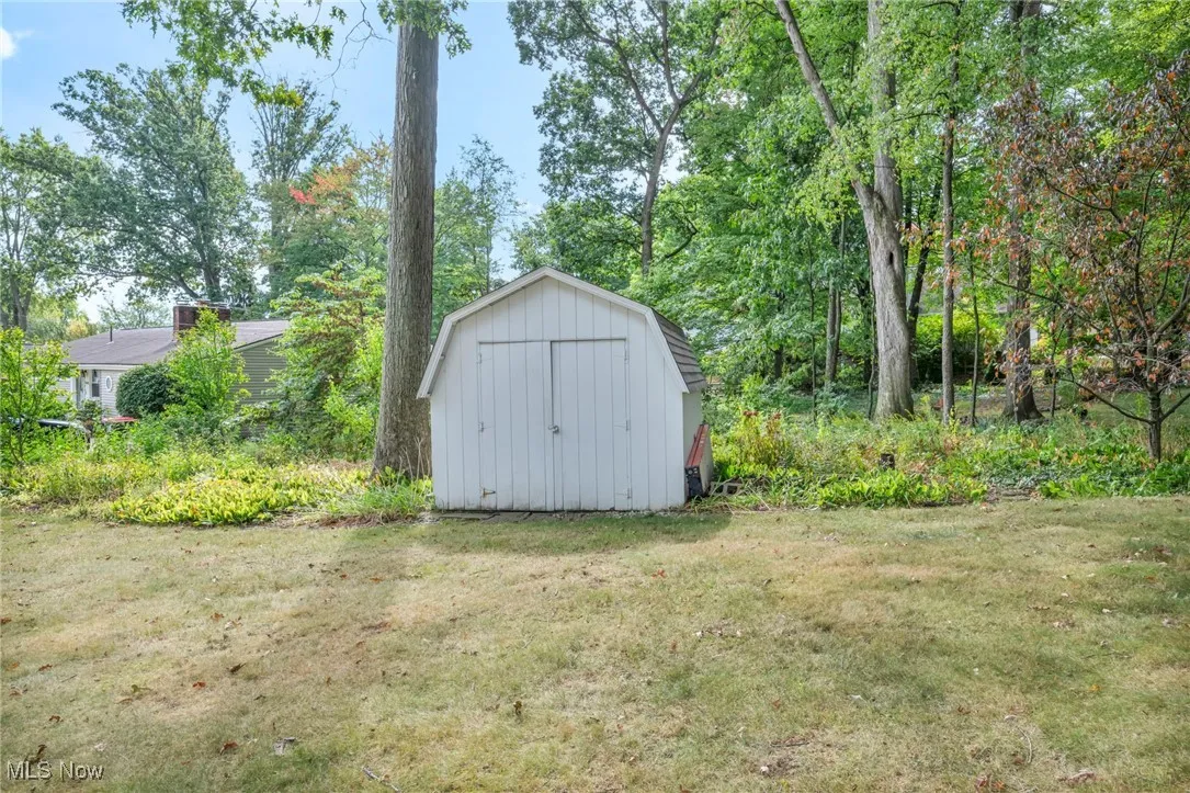 View of shed featuring view of scattered trees