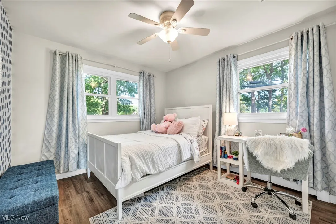 Bedroom with wood finished floors and ceiling fan