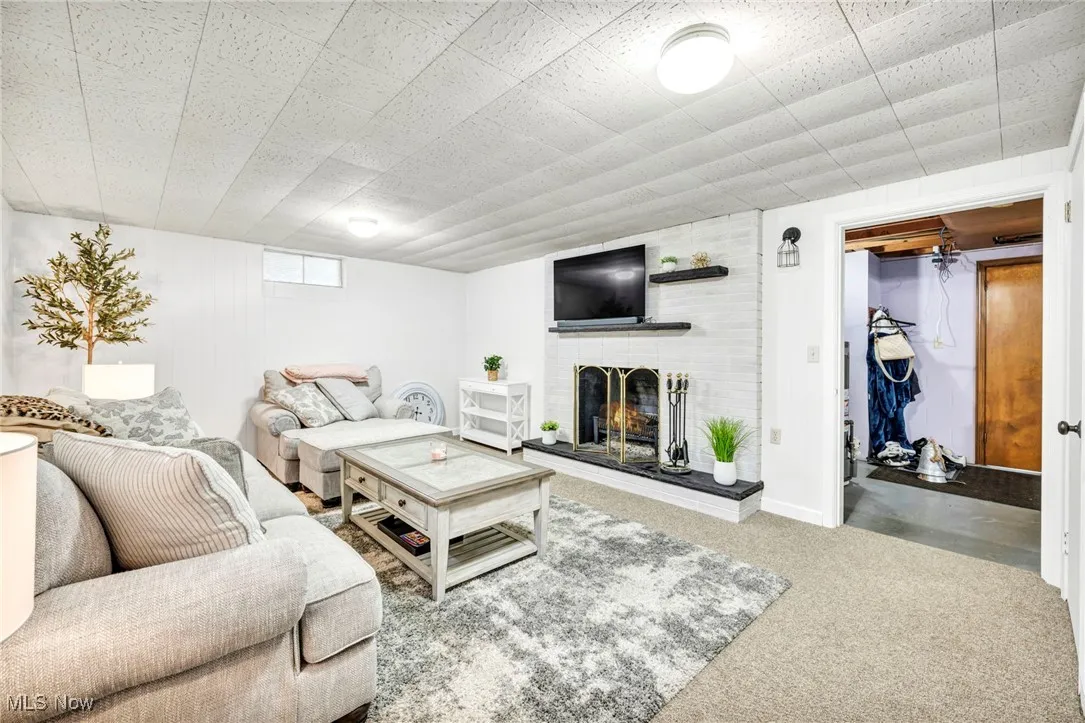 Living room with a fireplace and carpet floors