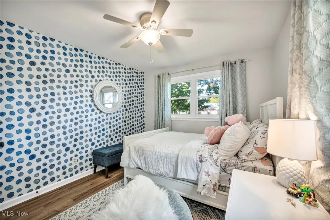 Bedroom featuring wood finished floors and a ceiling fan