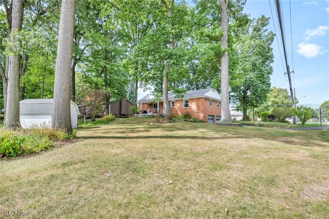 View of green lawn featuring an outdoor structure