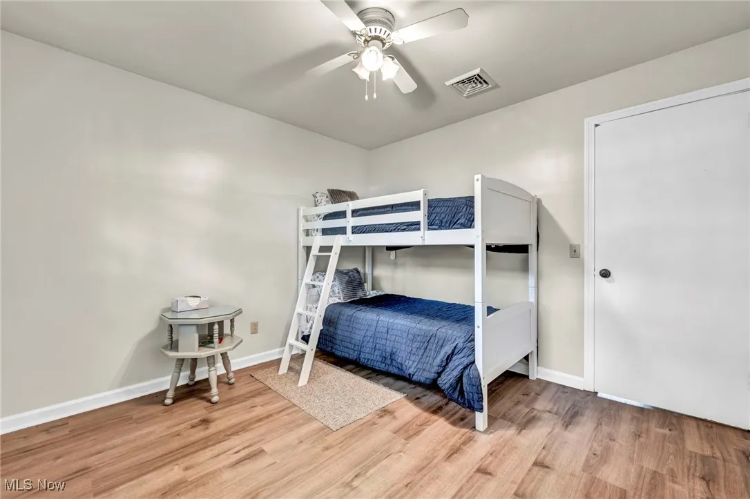 Bedroom with light wood-style flooring and a ceiling fan