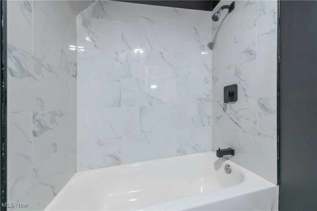 Full bathroom with bathtub / shower combination