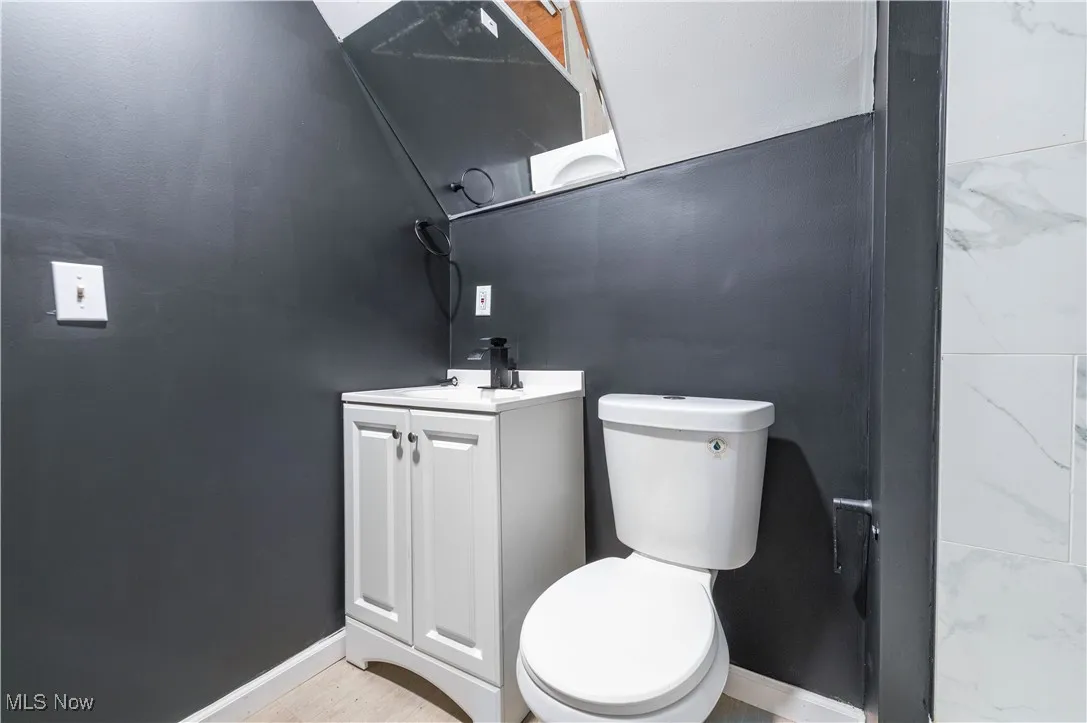 Half bathroom featuring baseboards and vanity