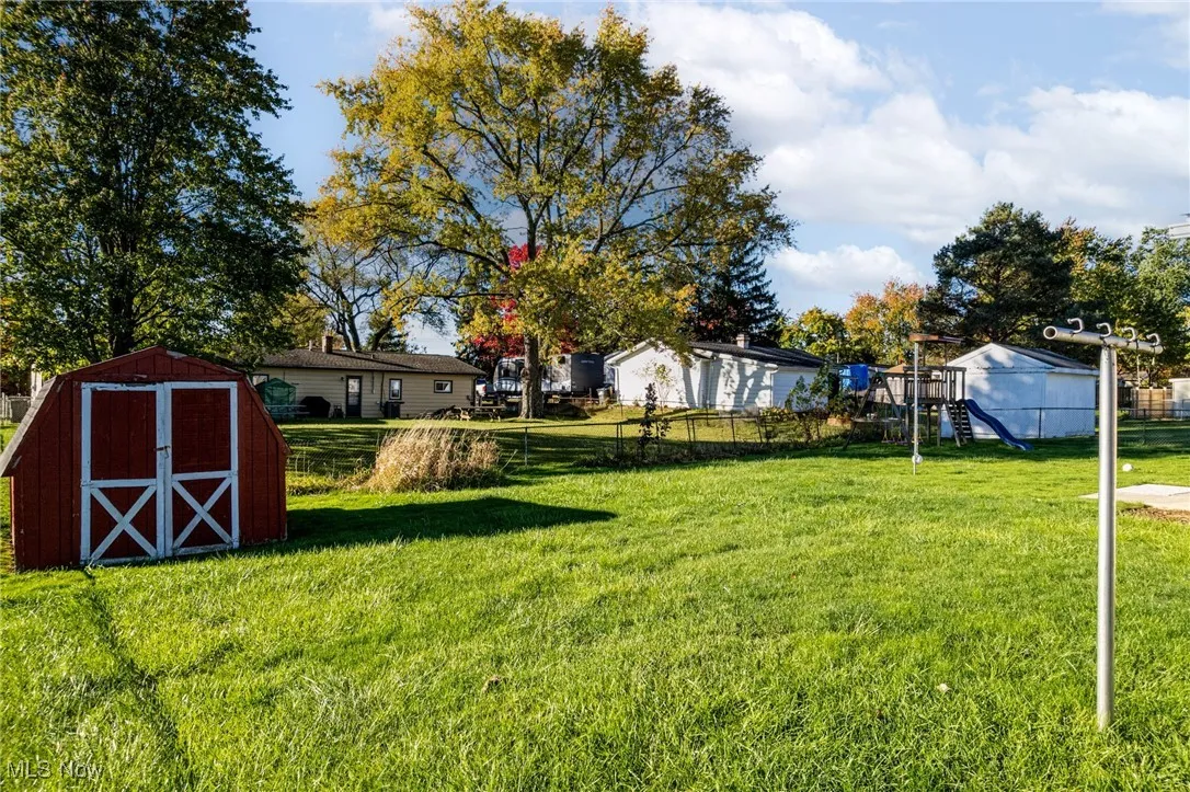 Fenced in back yard with shed