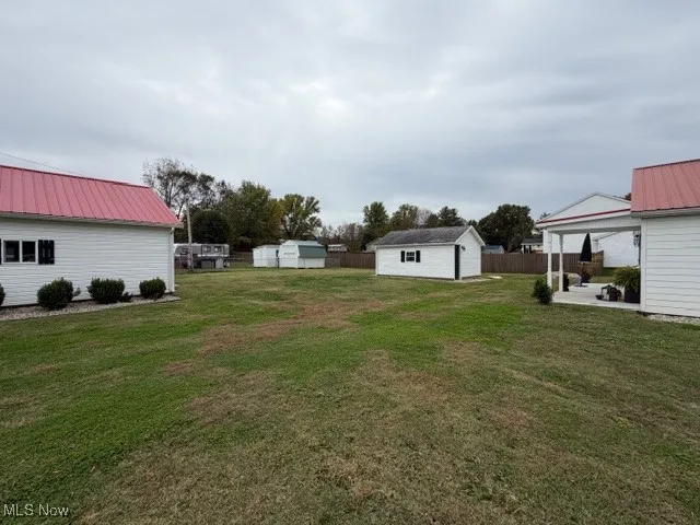 View of yard featuring a storage shed and a patio