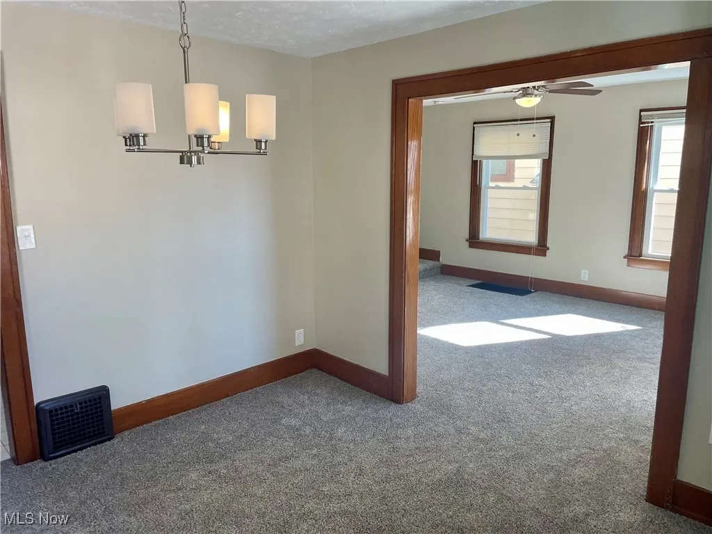Spare room with carpet floors, a textured ceiling, and a ceiling fan