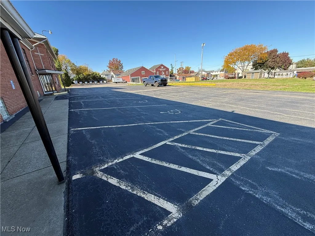 Uncovered parking lot featuring a residential view