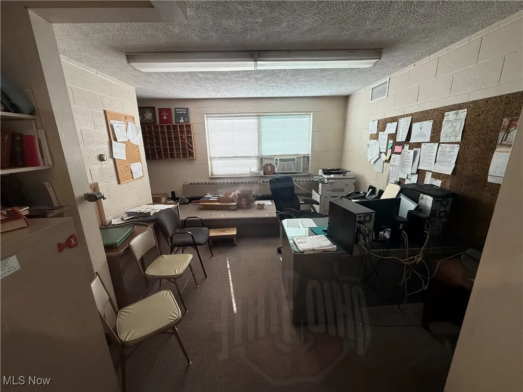 Office space featuring a textured ceiling