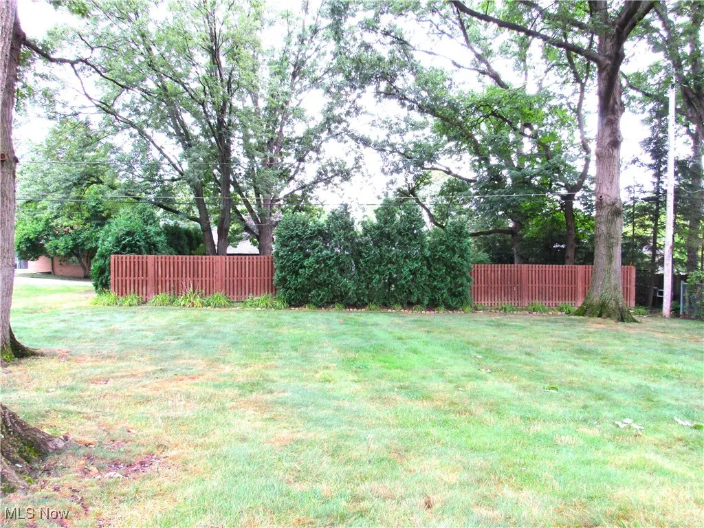 View of yard with view of wooded area