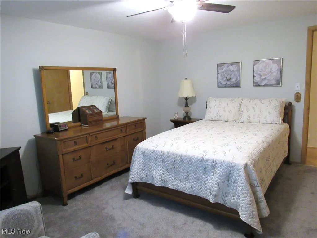 Bedroom with carpet floors and a ceiling fan