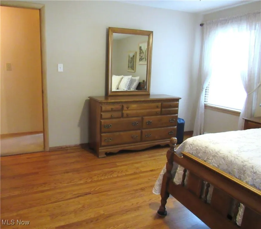 Bedroom featuring light wood-type flooring and baseboards
