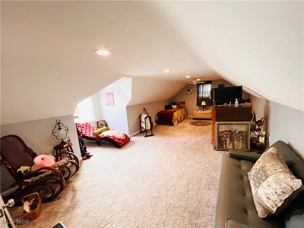 Recreation room with lofted ceiling, carpet floors, and recessed lighting