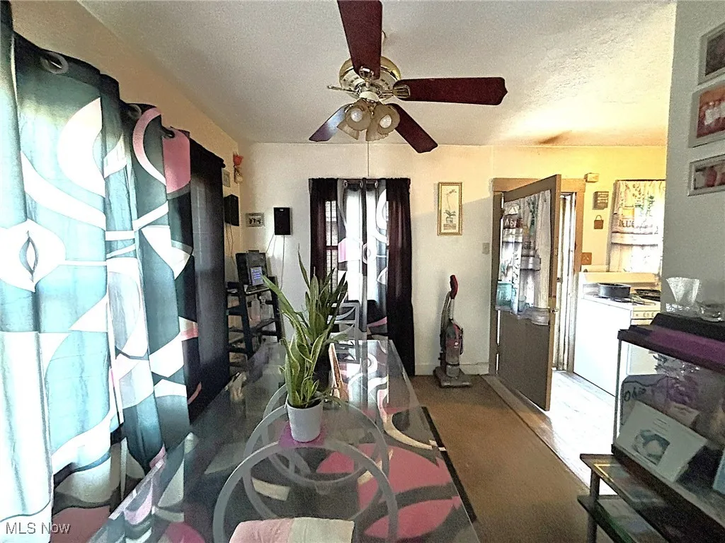 Dining room with a textured ceiling and ceiling fan