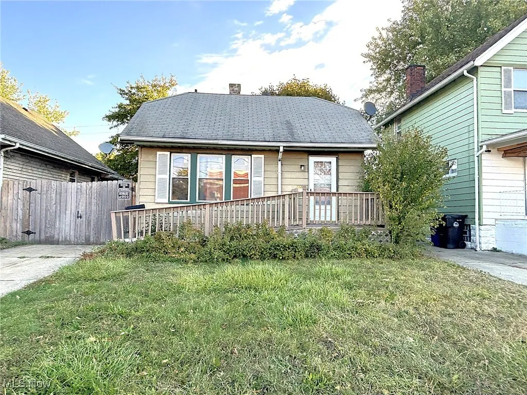 View of front of property with a chimney and roof with shingles